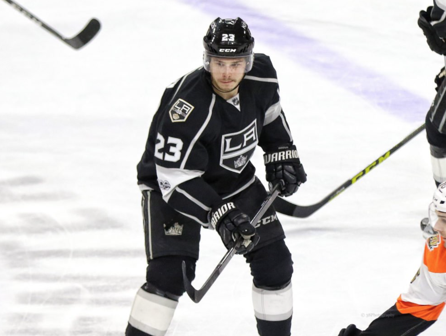 Dustin Brown holds up The Stanley Cup at an event where LA Kings